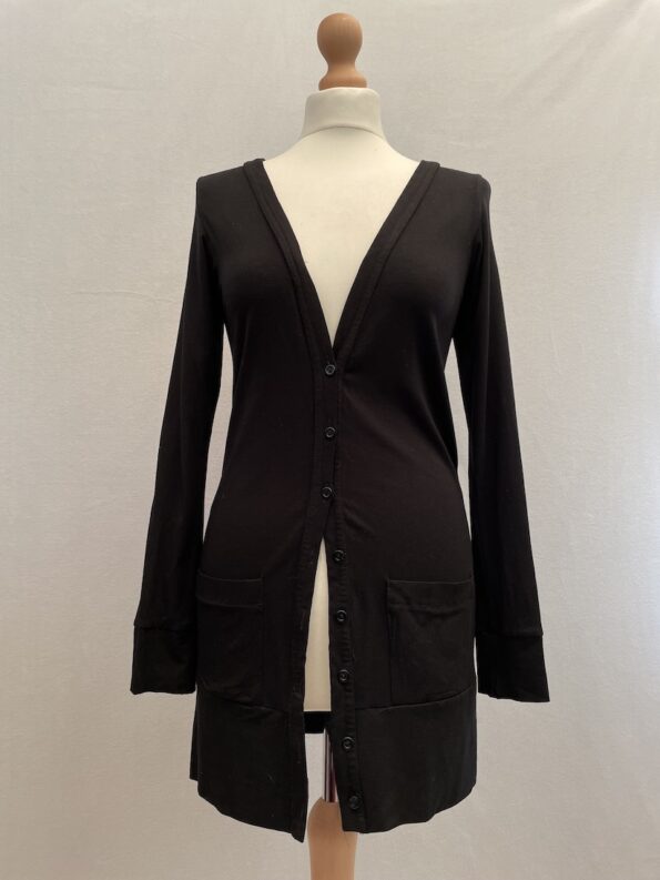 Black cardigan with button front closure and two small pockets at the front.