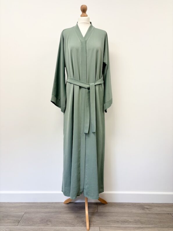 Hawaa Clothing green popper opening abaya in slight crinkle fabric, 54" long